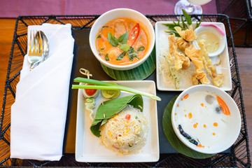 main course of Thai foods and appetizers presented beautifully with fancy garnish