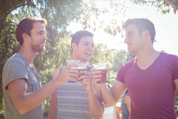 Happy friends in the park having beers