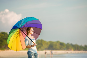 Young caucasian woman wearing sunglasses with colourful rainbow