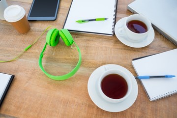 Overhead of coffee and headphone on the desk 