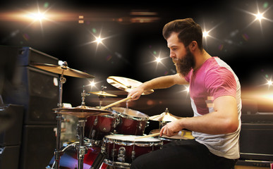 male musician playing cymbals at music concert