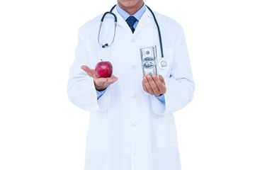 Doctor holding cash and red apple