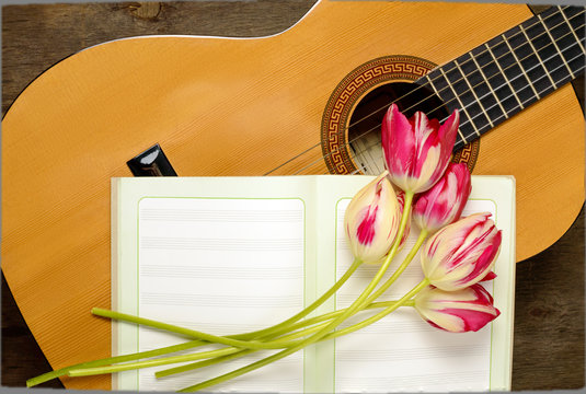 guitar, musical notes and a bouquet of tulips