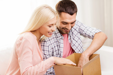 Fototapeta na wymiar happy couple with parcel box at home