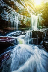 Foto op Plexiglas Tropische waterval met zonnestralen © Dmitry Rukhlenko