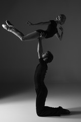 two young modern ballet dancers on gray studio background 
