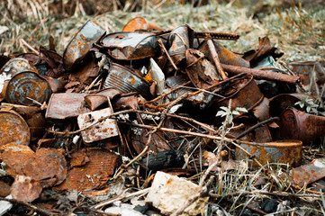Pile rusty cans garbage on nature