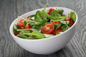 fresh summer organic salad with tomatoes cucumbers and spinach