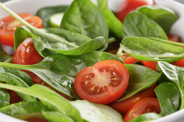 fresh summer organic salad with tomatoes cucumbers and spinach