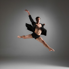 Fototapeta premium The young attractive modern ballet dancer jumping on white