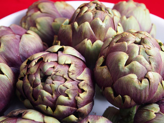 Many artichokes in a white plate