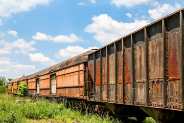 Fototapeta na wymiar Old Rusty Train Cars Curving