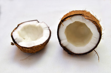 the broken fresh coconut on a white background