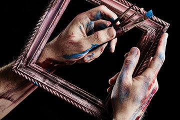 Wooden frame in hands. Conception of art