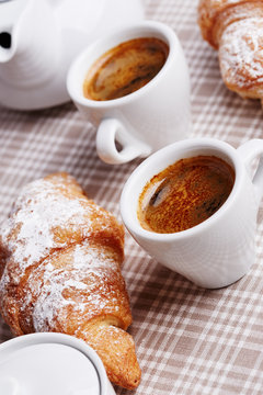 Cups of coffee with croissant