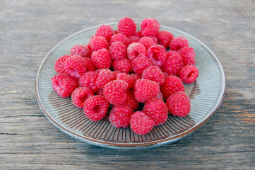 fresh fruits background with raspberries on rustic wooden table