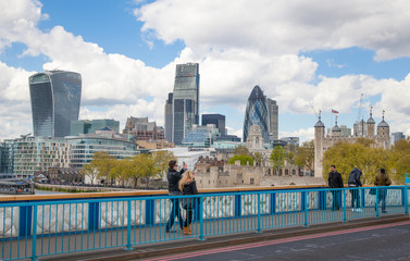 Fototapeta na wymiar LONDON, UK - APRIL 30, 2015: Tower of London and modern buildings of finance aria