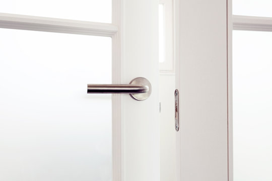 Open White Door With Metallic Handle