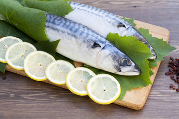 Fresh mackerel in grape leaves with lemon slices