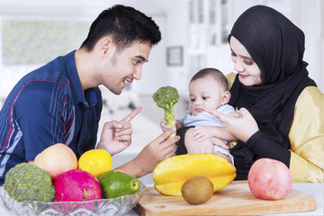 Fototapeta premium Muslim parents with baby and healthy food