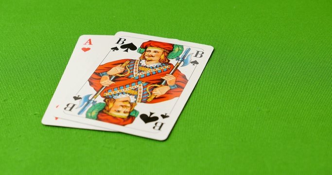 A black jack player lies his cards on the table and shows his winning combination - a black jack