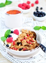 Healthy breakfast, yogurt with granola and berries on the white table