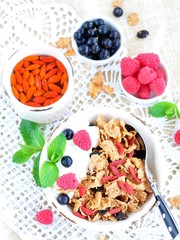 Healthy breakfast, yogurt with granola and berries on the white table