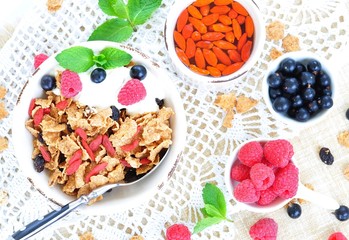 Healthy breakfast, yogurt with granola and berries on the white table