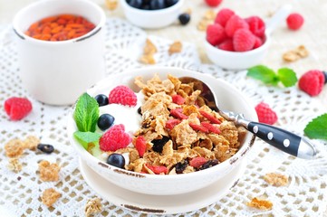 Healthy breakfast, yogurt with granola and berries on the white table