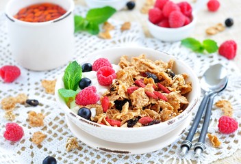 Healthy breakfast, yogurt with granola and berries on the white table