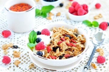 Healthy breakfast, yogurt with granola and berries on the white table