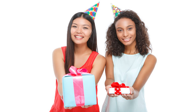 Cheerful girls holding birthday presents 