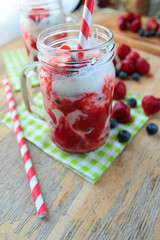 Glass with strawberry milkshake with color sipper