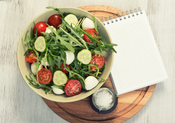 menu. blank notepad and vegetable salad