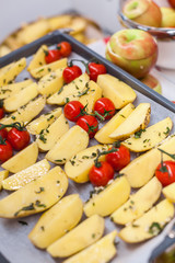 Potato slices with fresh tomatoes and spices