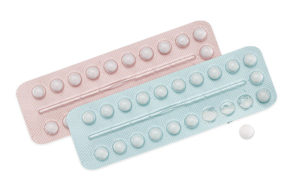 Male and female contraceptive pills, pink and blue on white