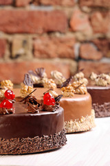 Cream cakes on wall background
