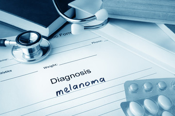 Diagnostic form with diagnosis melanoma and pills.