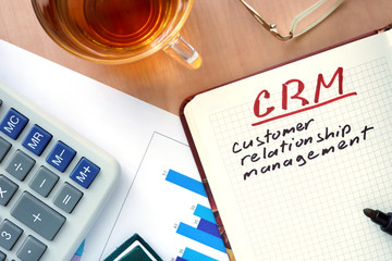 Notepad with words CRM customer relationship management  concept and marker.
