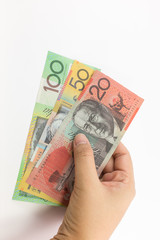 Young girl's hand hold banknote on white background.