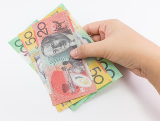 Young girl's hand hold banknote on white background.