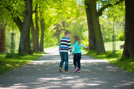 Two Happy Children Walking In Park