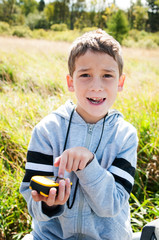 young boy with a gps unit geocaching