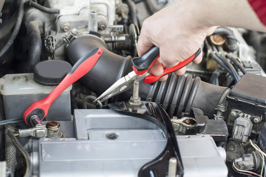 The process of repairing vehicle using pliers