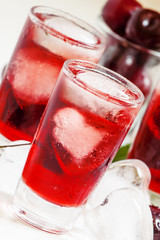 Ice red drink with ice in a heart shape, selective focus