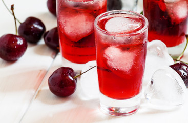 Ice red drink with ice in a heart shape, selective focus