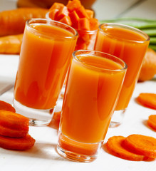 Fresh carrot cocktail glasses, selective focus