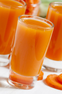 Fresh carrot cocktail glasses, selective focus