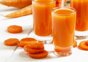 Fresh carrot cocktail glasses, selective focus
