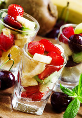Salad from fruit and berries in glasses, selective focus